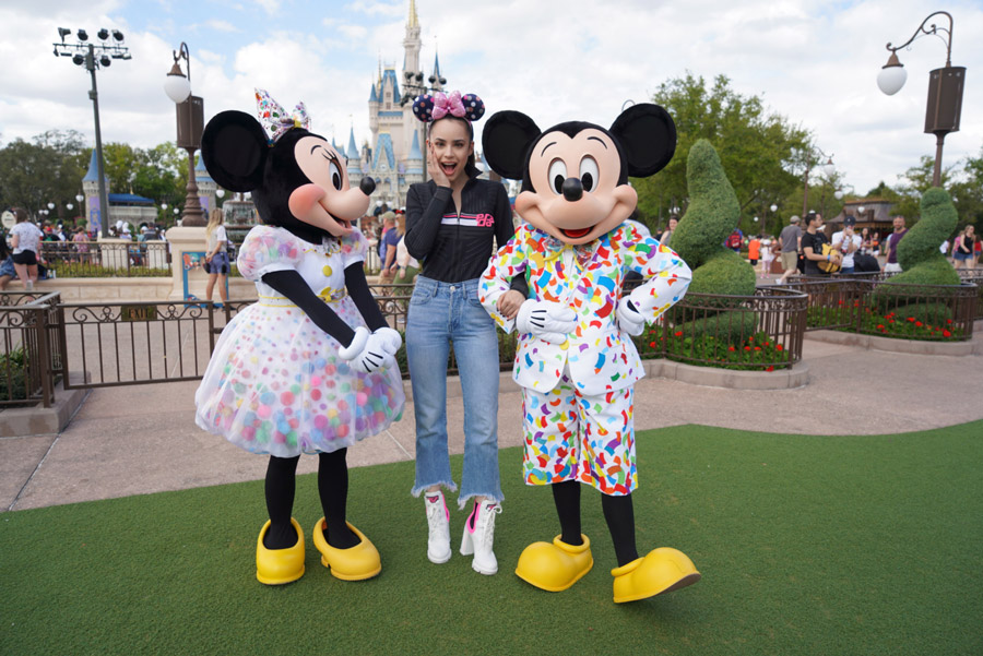 Actress Sofia Carson poses with Mickey Mouse and Minnie Mouse at Magic Kingdom Park