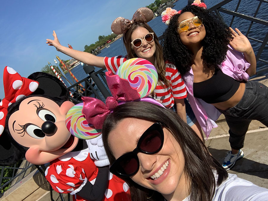 Katie, Aisha, and Meghann taking selfies with Minnie Mouse