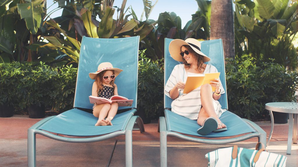 Mom and Daughter sitting in pool chairs