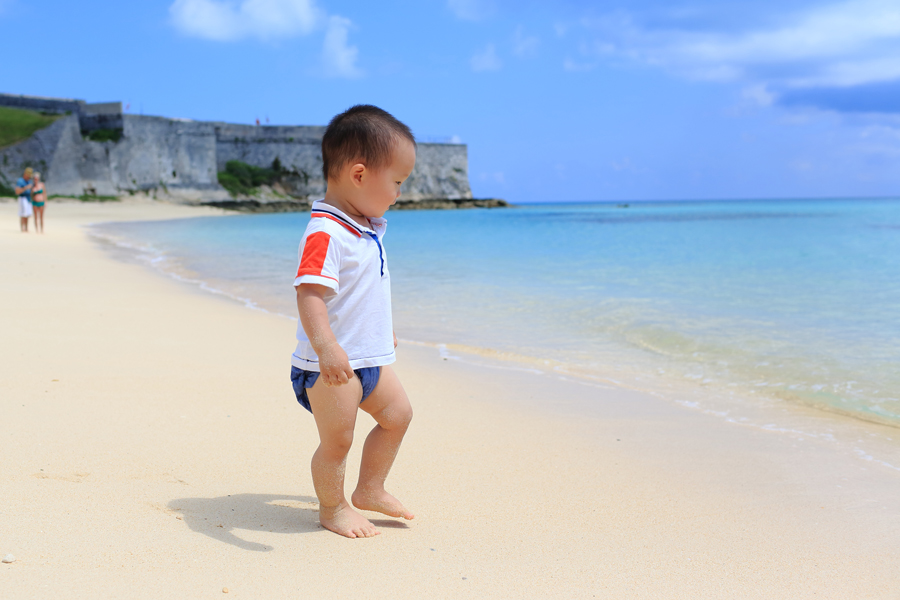Toddler plays on beach