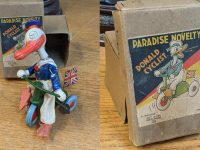 A 1930s Japanese Paradise Novelty Donald Duck cyclist banner