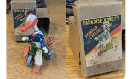 A 1930s Japanese Paradise Novelty Donald Duck cyclist banner